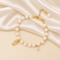 Baby Keepsake Pearl Bracelet with Name Foot and Initial Charm - Glaxias